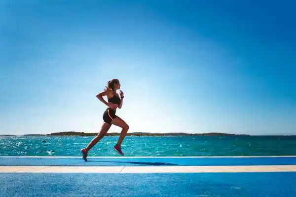 Woman running showing strong leg muscle Solihull
